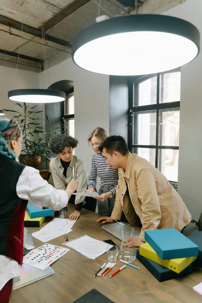 Diverse team of young professionals brainstorming together in a contemporary office setting.